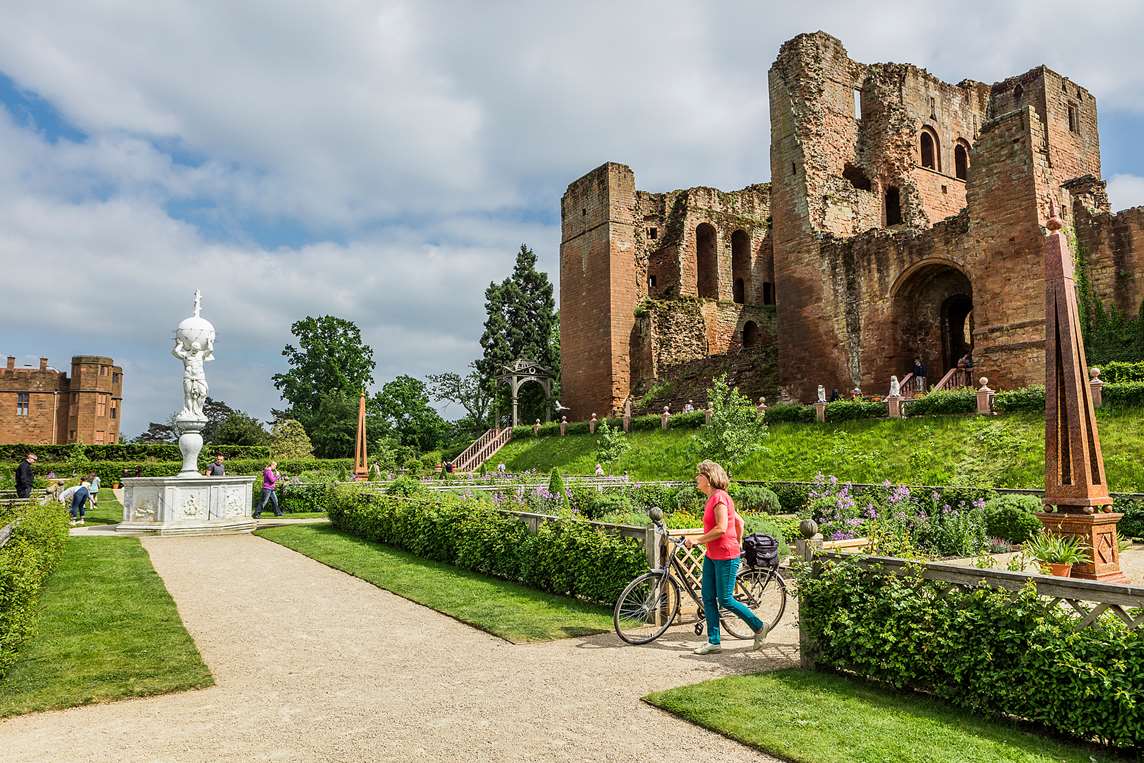 Image: visitor walking with bicycle at Kenilworth Castle and Elizabethan Garden