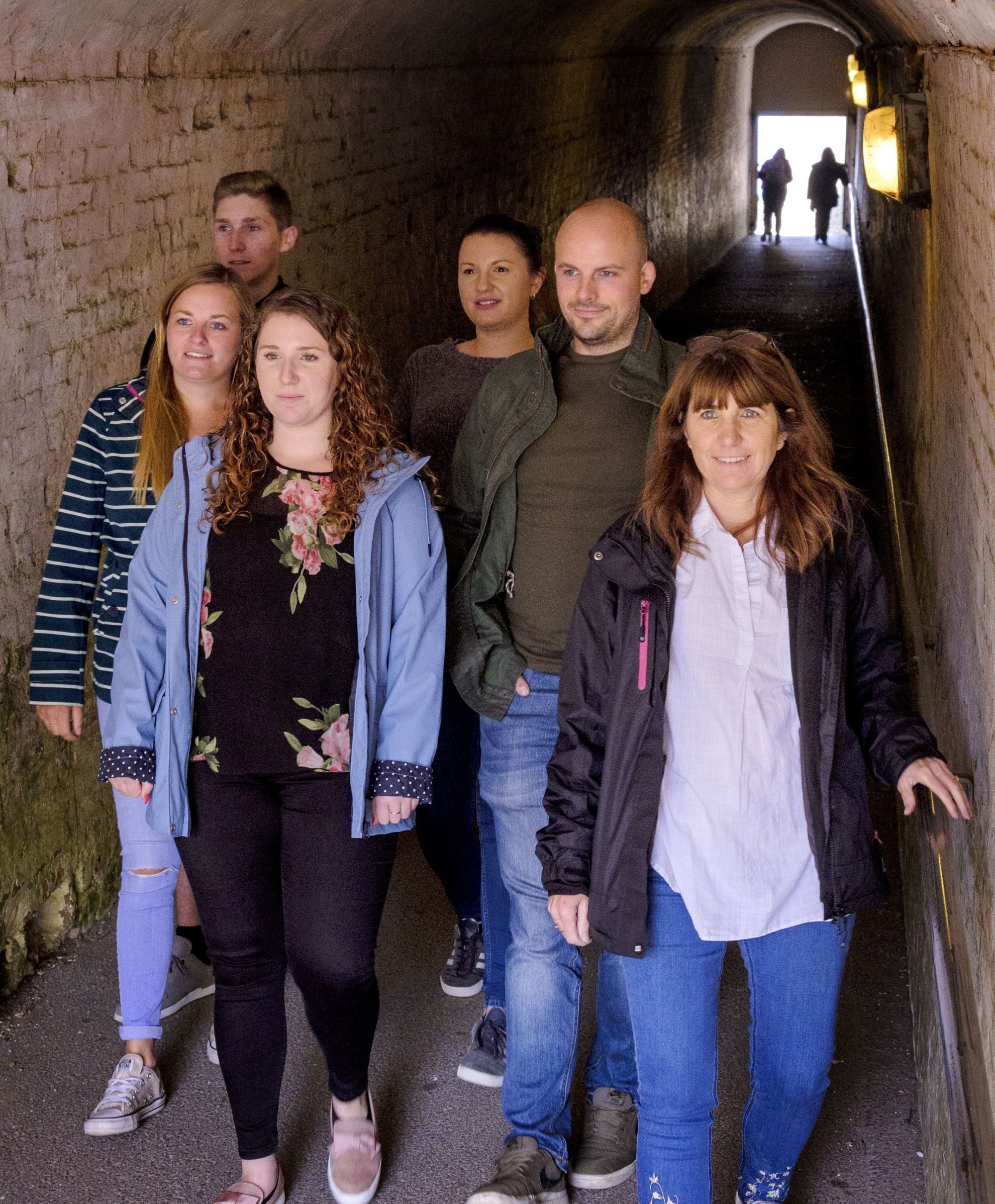 Image: A family walking through the wartime tunnels at Dover Castle 