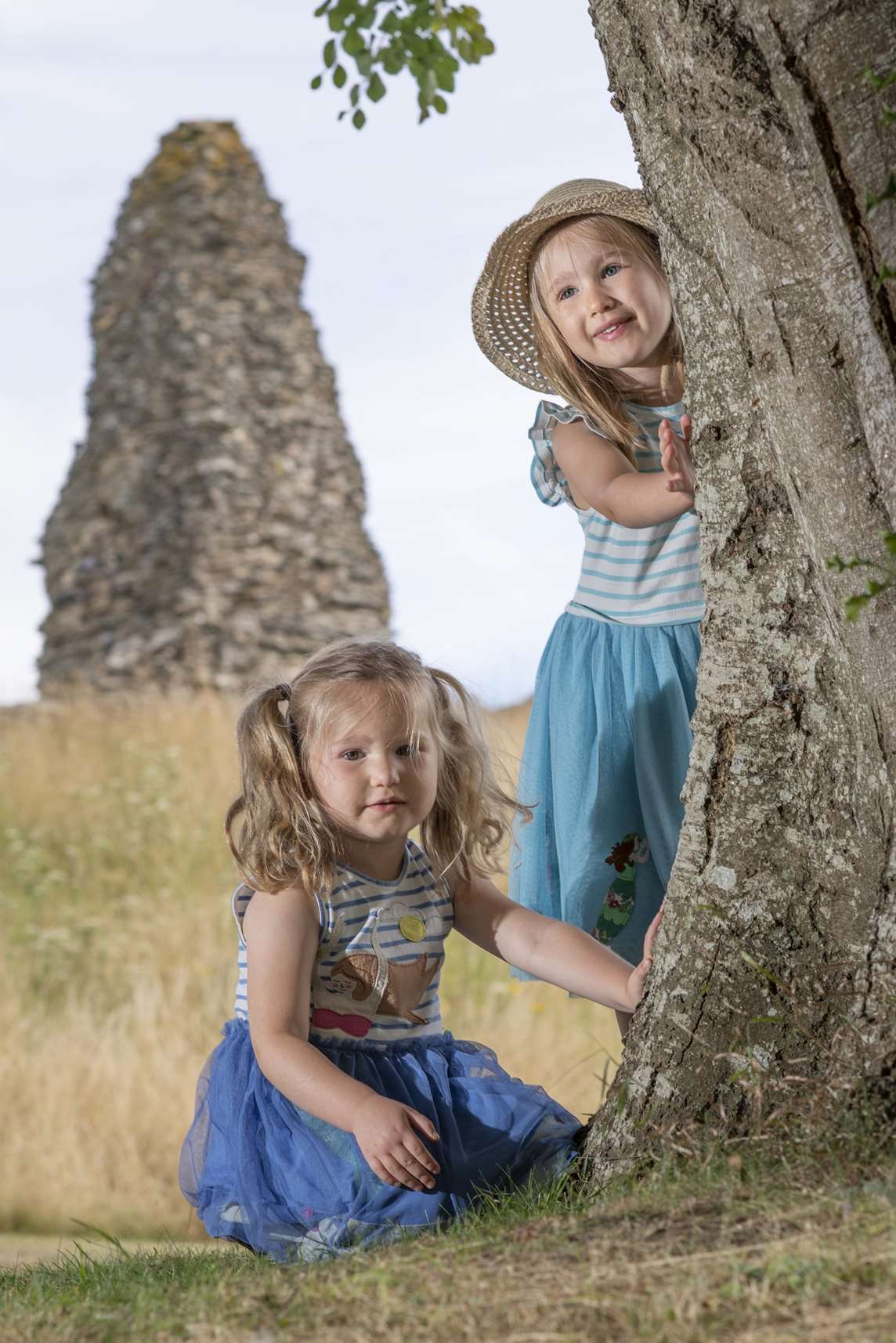 Image: Two children touch the bark of a tree at Launceston Castle