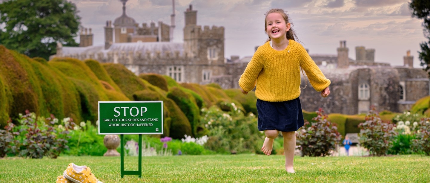 Image: Young girl running barefoot across a lawn at Walmer Castle and Gardens