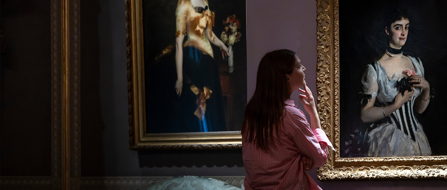 A young woman looks at a portrait of a glamorous young woman (Mrs Wilton Phipps by John Singer Sargent)