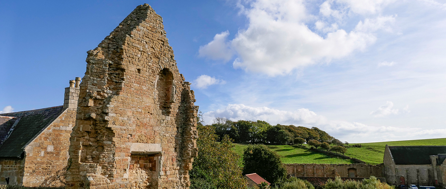 A large stone wall which are part of the remains of Abbotsbury Abbey.