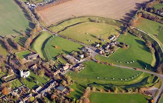 Aerial view of Avebury showing the stone circle, church and neighbouring Alexander Keiller Museum