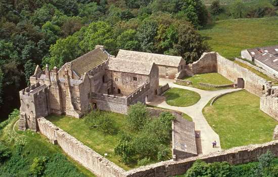 Aerial view of the substantial remains of Aydon Castle perched on the edge of scarp above Cor Burn Aerial view of the substantial remains of Aydon Castle perched on the edge of scarp above Cor Burn