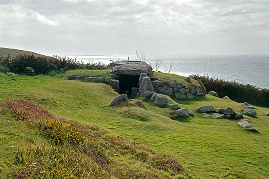 The stone entrance to Bants Carn with the ocean in the background The stone entrance to Bants Carn with the ocean in the background