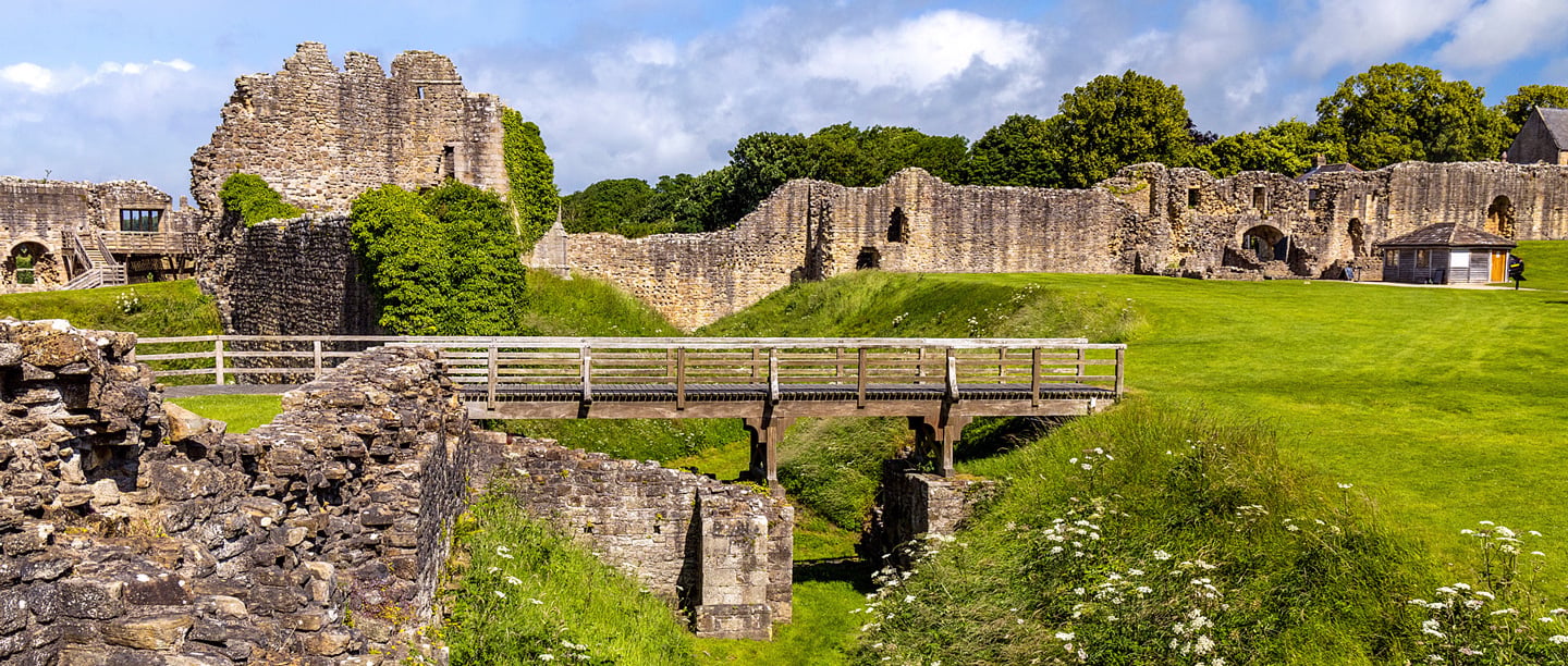 A view of the stone walls and wooden bridge at Barnard Castle.