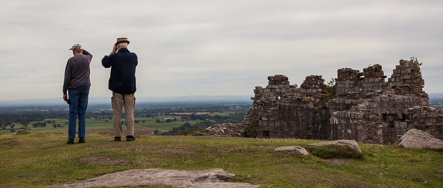 Two visitors enjoying the view at Beeston Castle Two visitors enjoying the view at Beeston Castle