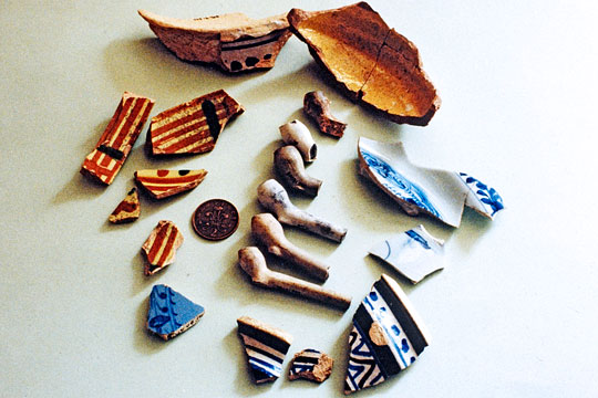 A collection of early small-bowled tobacco pipes and ceramix shreds from Berry Pomeroy A collection of early small-bowled tobacco pipes and ceramix shreds from Berry Pomeroy