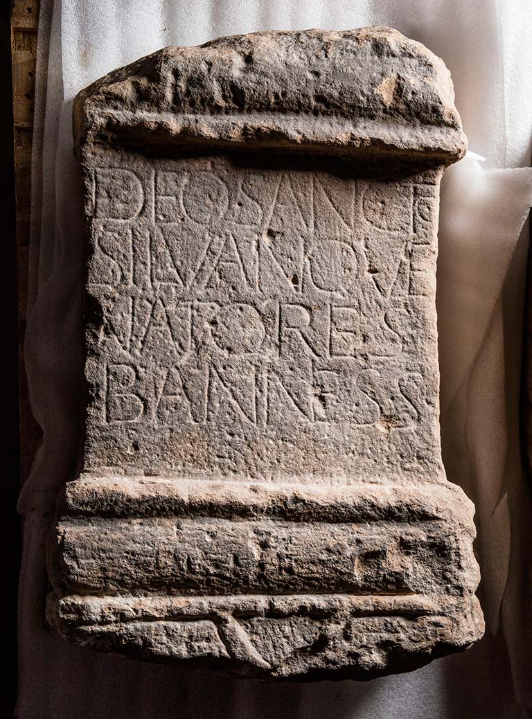 A photograph of a stone altar with latin inscription