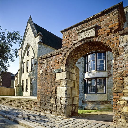 Exterior of Blackfriars priory viewed through the entrance archway