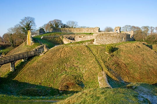 The inner bailey at Castle Acre ruined walls on the raised mound approached by a wooden bridge