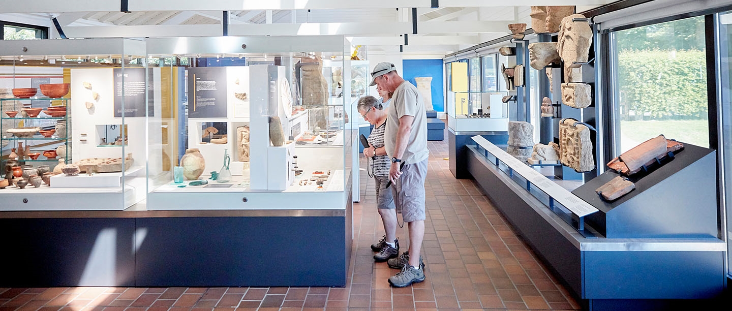 Visitors examine items in the museum at Corbridge Roman Town