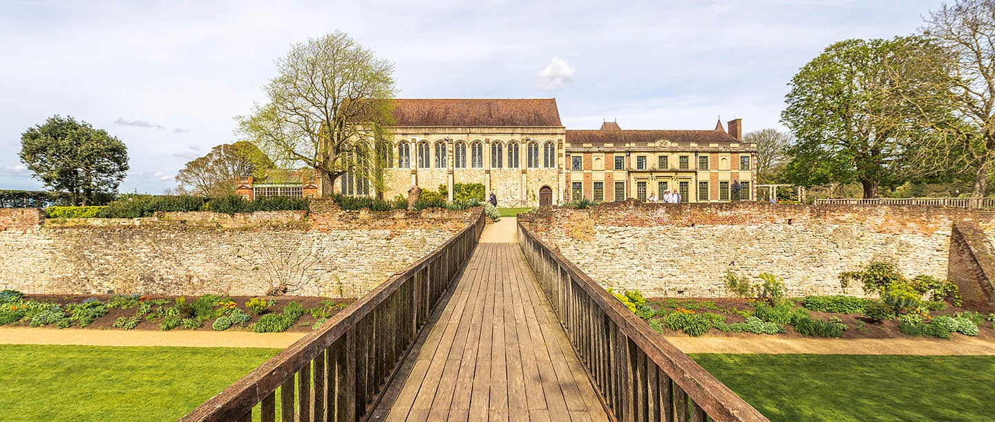 A view of Eltham Palace across a bridge