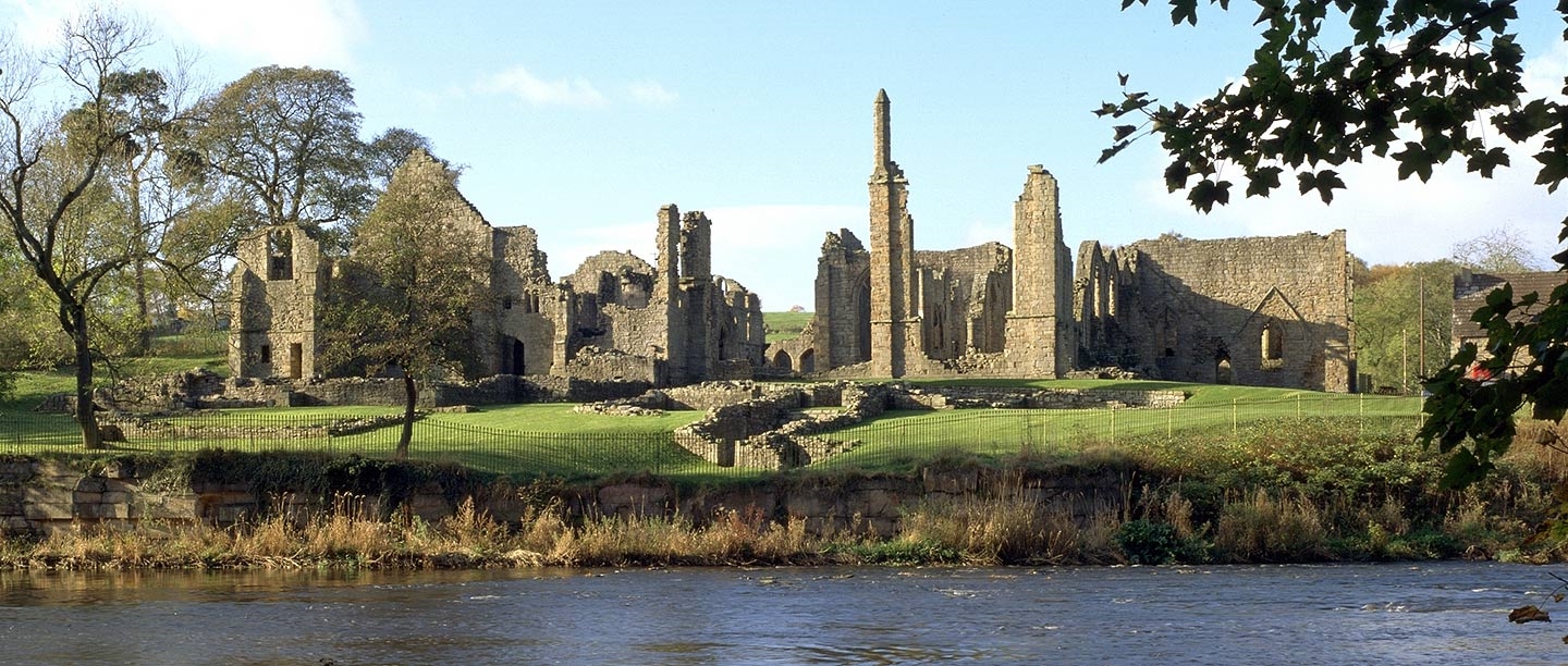 The remains of Finchale Priory seen from across the river Wear