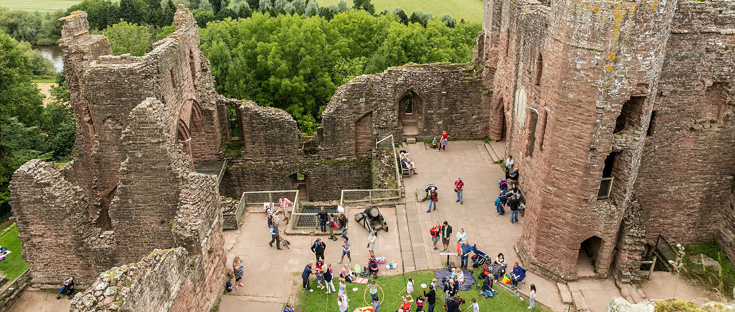 A overhead view of Goodrich Castle, showing visitors in the keep yard