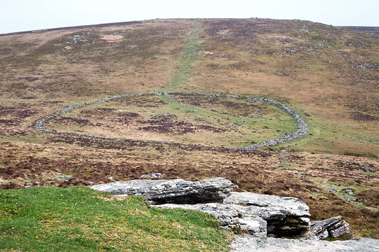 View of Grimspound from Hookney Tor to the north looking towards Hameldown Tor. The original entrance is to the south east View of Grimspound from Hookney Tor to the north looking towards Hameldown Tor. The original entrance is to the south east