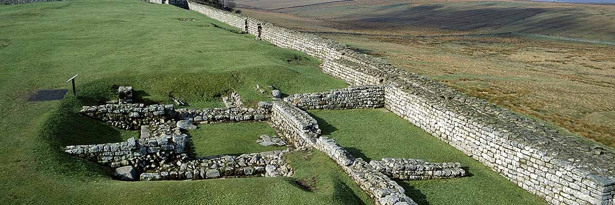 View along the north wall of Housesteads Fort, showing the foundations of turret 36b partially overlain by later walls