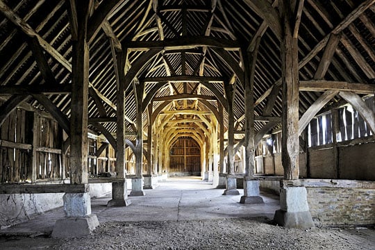 The interior of the great barn, looking towards the north end, the massive square profile posts supported on stone stanchions The interior of the great barn, looking towards the north end, the massive square profile posts supported on stone stanchions