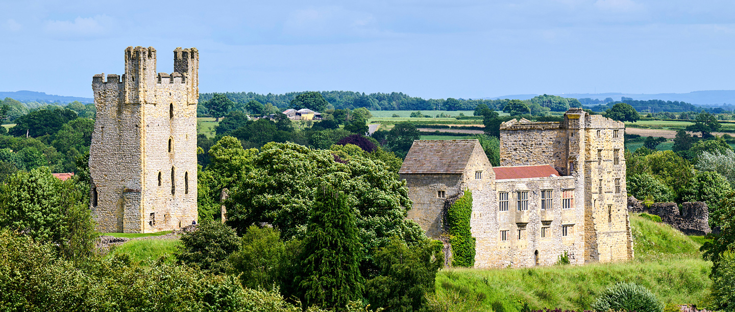 A far away view of Helmsley Castle and the tall stone tower. 