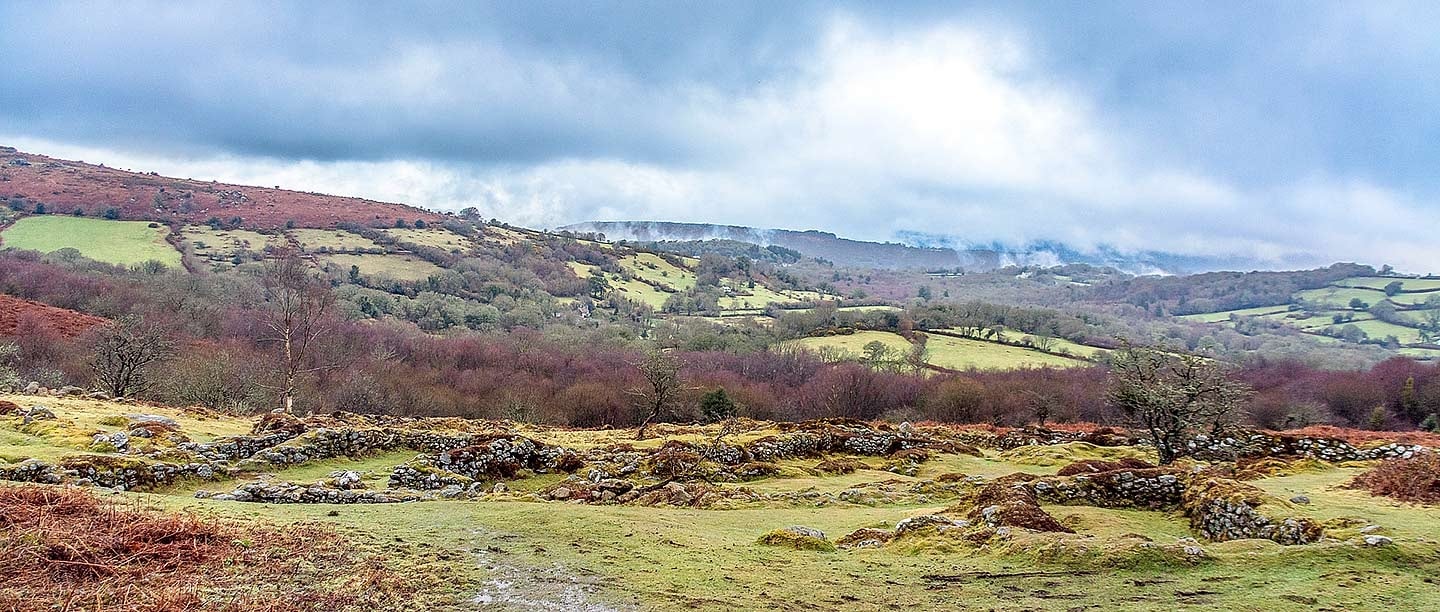 The remains of Hound Tor Deserted Medieval Village, surrounded by moorland