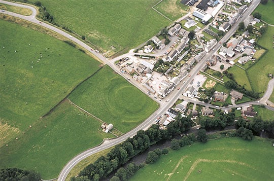 Aerial view of King Arthurs Round Table earthworks abutting the village of Eamont Bridge