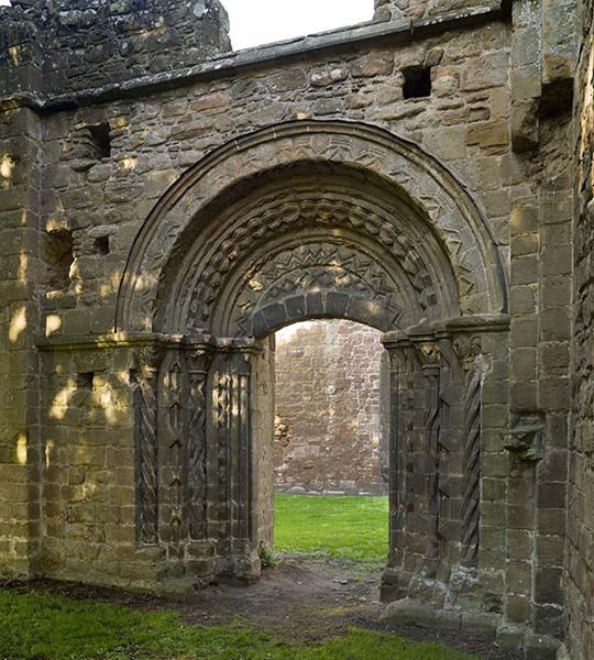 The processional arch leading from the cloister into the abbey church, lavishly decorated with chevron patterns, dates from the 12th century