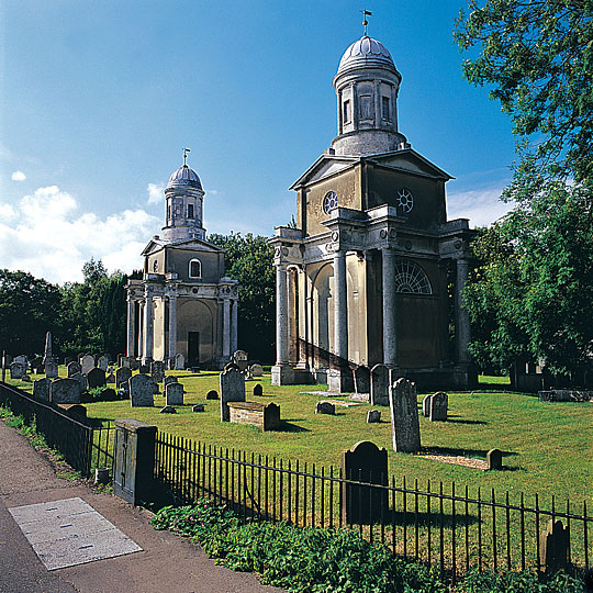 An outside view of the two towers with gravestones in the foreground