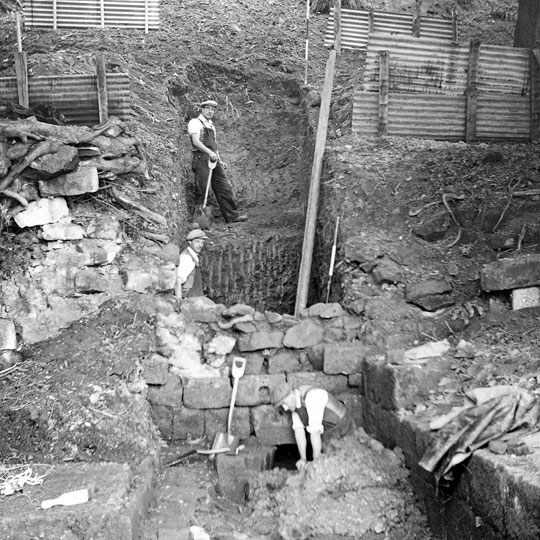 Black and white photograph of excavations at Mount Grace priory in 1957, two diggers in flat caps, waistcoats and rolled up sleeves Black and white photograph of excavations at Mount Grace priory in 1957, two diggers in flat caps, waistcoats and rolled up sleeves