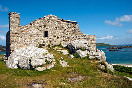 The Old Blockhouse built on a rocky outcrop with the sea in the background The Old Blockhouse built on a rocky outcrop with the sea in the background