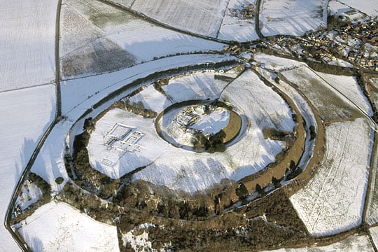 Aerial photograph of Old Sarum looking north-east, with the earthworks of the Iron Age ramparts showing up very clearly against the snow