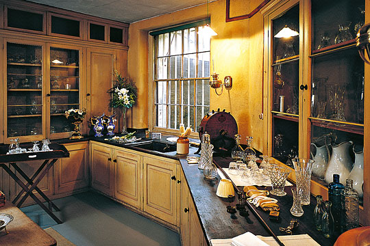 One of the Table Deckers' Rooms at Osborne, with glassware, crockery and cutlery on worktops and in cupboards plus a valet tray laid out