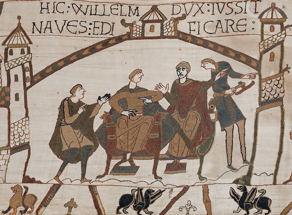 Scene from the Bayeux Tapestry showing Duke William (left of centre) in council with his half-brother, Bishop Odo of Bayeux. After hearing the news of Harold’s coronation from a messenger, he is ordering ships to be built for the invasion fleet