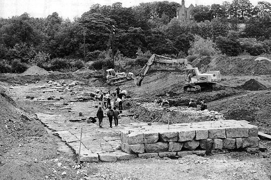 Black and white photograph of the bridge abutment and pavement during excavation