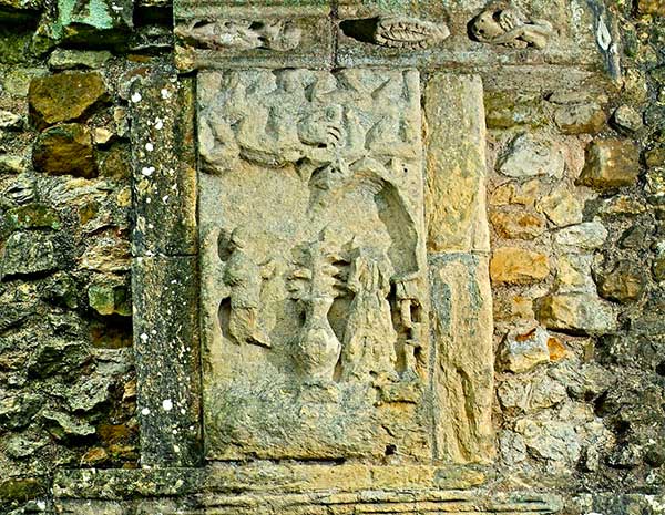 The rectangular yellow sandstone carving on a brick wall