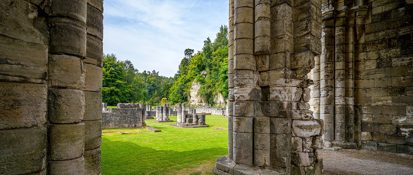 A view of Roche Abbey ruins on a sunny day.