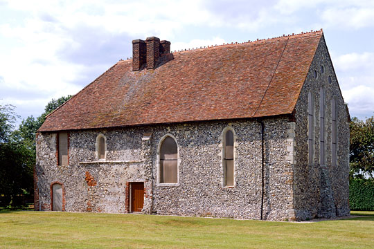 St Johns Commandery with flint walls and red tiled roof with chimneys St Johns Commandery with flint walls and red tiled roof with chimneys
