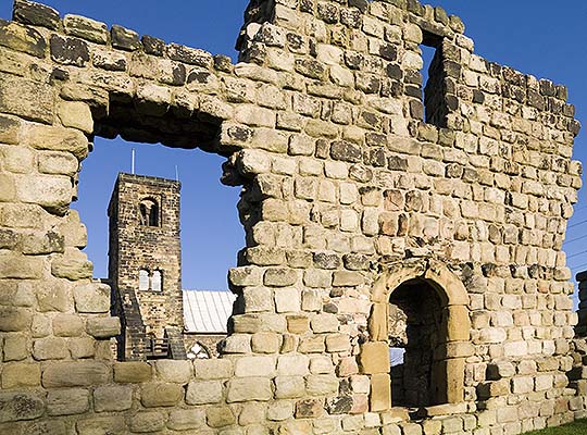 The Anglo-Saxon tower of St Paul's Church, seen through the monastic ruins