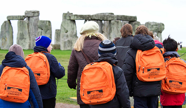 School children being led on a tour around Stonehenge
