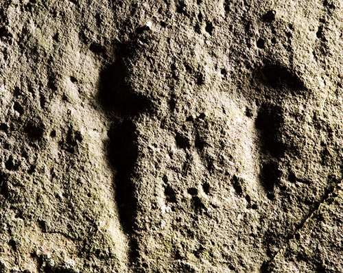 The carved outlines of Bronze Age tools on the upright stone of a trilithon