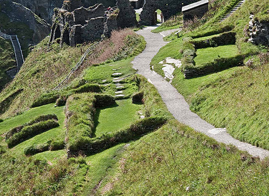 The remains on Tintagel island. To the left of the path are some of the remains of the 5th- to 7th-century settlement The remains on Tintagel island. To the left of the path are some of the remains of the 5th- to 7th-century settlement