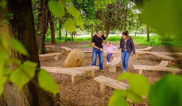A family enjoys the new play trail. A family enjoys the new play trail.