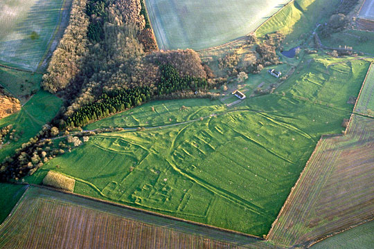 Aerial view of the village, looking south, with raking light highlighting the low earthworks