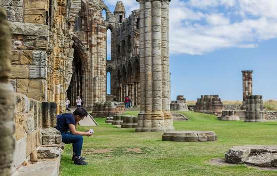 York to Whitby the Scenic Way: A Sightseeing Transfer with Moors and Coast on the Way Whitby Abbey overlooking the harbour and Yorkshire coast