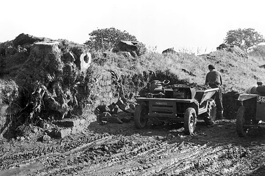 Black and white photograph showing machine clearance of debris from Hadrian's Wall at Willowford in 1955