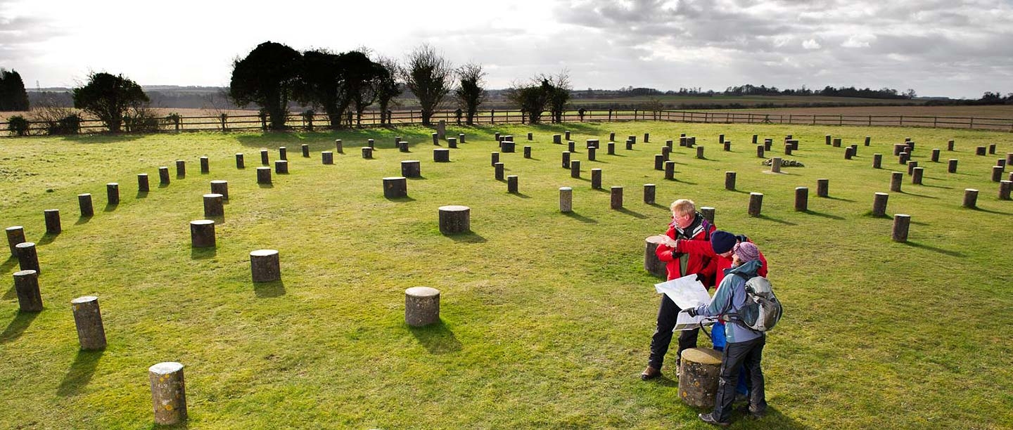 View of Woodhenge showing visitors at the site and the concrete posts that mark the positions of the wooden posts of the monument 