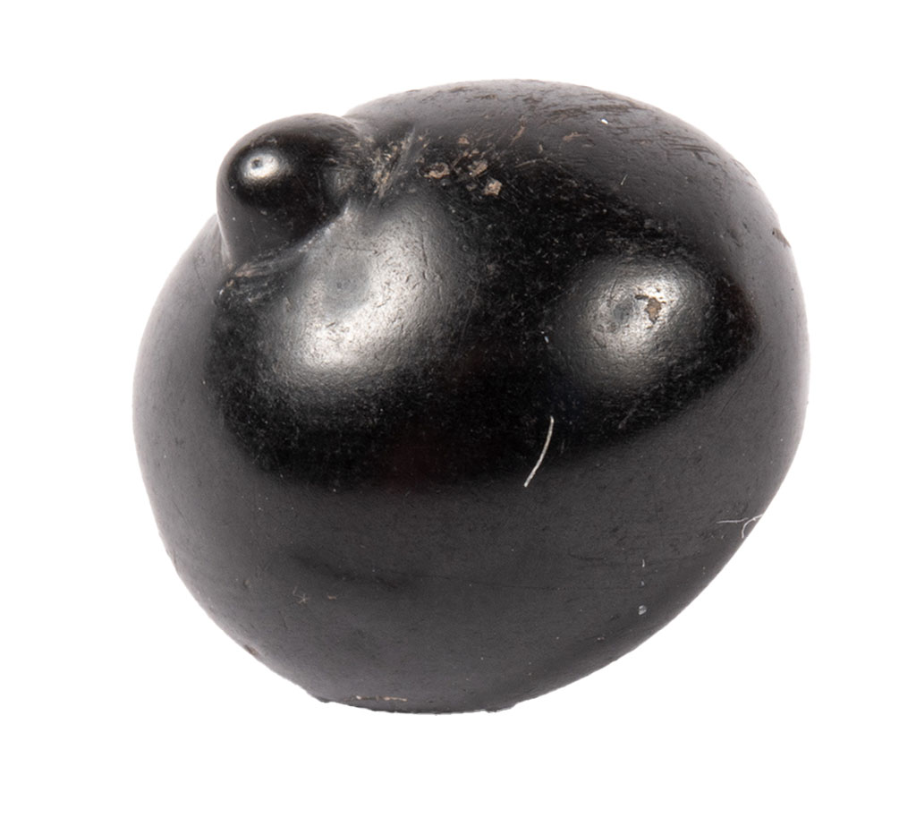 This amulet is made from jet, which is black in colour, and shaped like a breast, with a nipple at the top