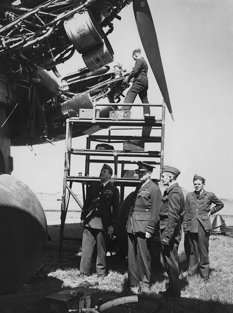 Sir Arthur Harris (centre with peaked cap) inspecting ground crew servicing a Halifax bomber, 10 May 1943
