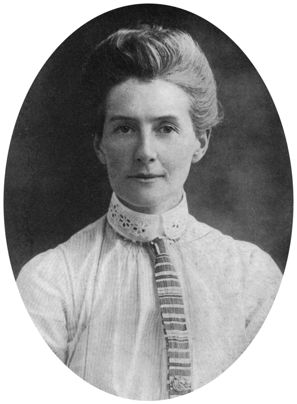 A black and white bust photograph of Edith Cavell