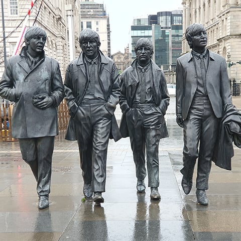 Metal statues of the Beatles in situ on a Liverpool street