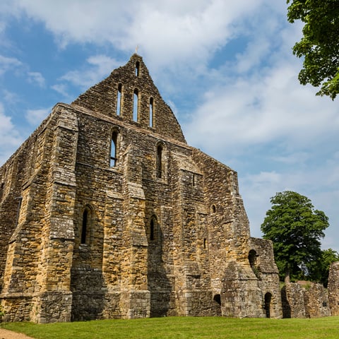 A low angle view of Battle Abbey underneath a blue sky.